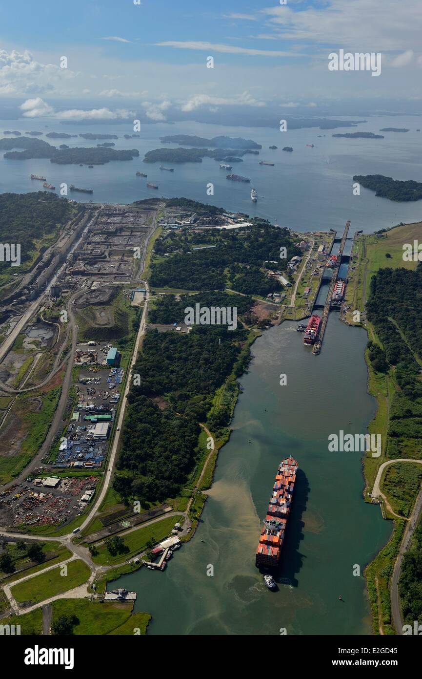 Panama Colon province Panama Canal Panamax cargo passing Gatun locks construction of new locks on left and Gatun Lake in background (aerial view) Stock Photo