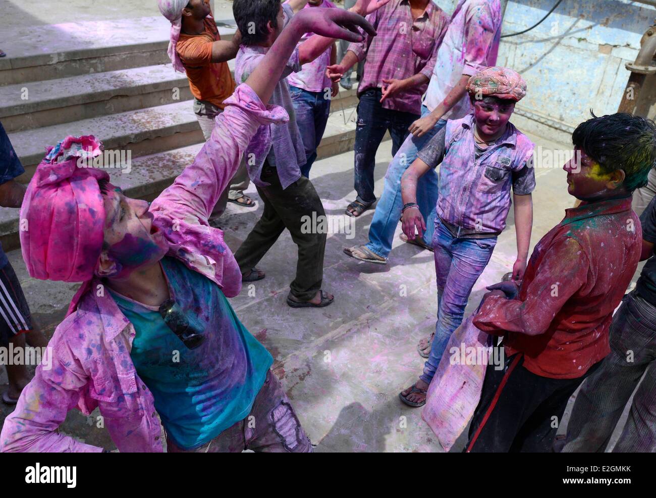 India Uttar Pradesh State Mathura young boys throws coloured powder during Holi festival celebrations Stock Photo