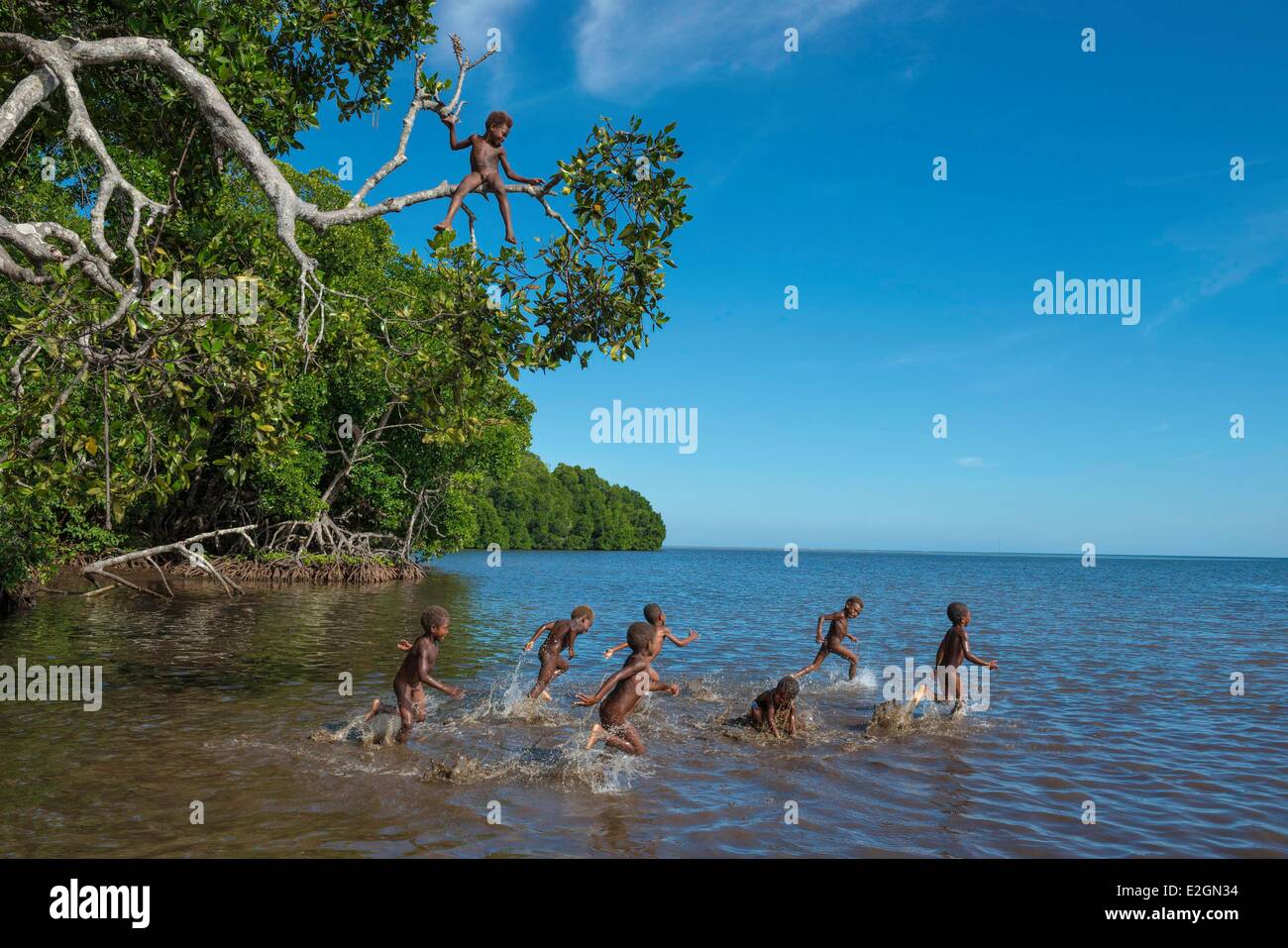 Papua New Guinea New Britain island West New Britain province Cap Gloucester district Kimbe area Akonga village kid playing in mangrove swamp Stock Photo