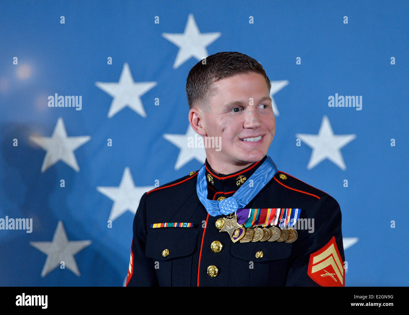 Washington, DC, USA. 19th June, 2014. William 'Kyle' Carpenter receives the Medal of Honor from U.S. President Barack Obama during a ceremony in the East Room of the White House in Washington, DC, the United States, on June 19, 2014. Carpenter received the medal for covering a grenade to save fellow Marines during a Taliban attack in November 2010. Carpenter is the eighth living recipient chosen for the highest military award. Credit:  Yin Bogu/Xinhua/Alamy Live News Stock Photo