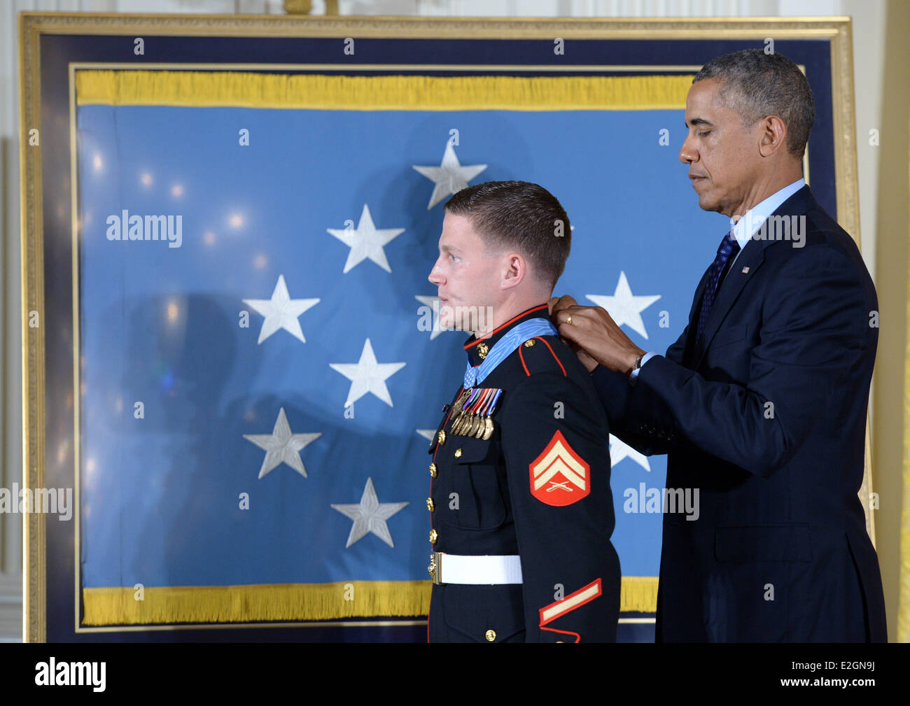 Washington, DC, USA. 19th June, 2014. William 'Kyle' Carpenter (L) receives the Medal of Honor from U.S. President Barack Obama during a ceremony in the East Room of the White House in Washington, DC, the United States, on June 19, 2014. Carpenter received the medal for covering a grenade to save fellow Marines during a Taliban attack in November 2010. Carpenter is the eighth living recipient chosen for the highest military award. Credit:  Yin Bogu/Xinhua/Alamy Live News Stock Photo