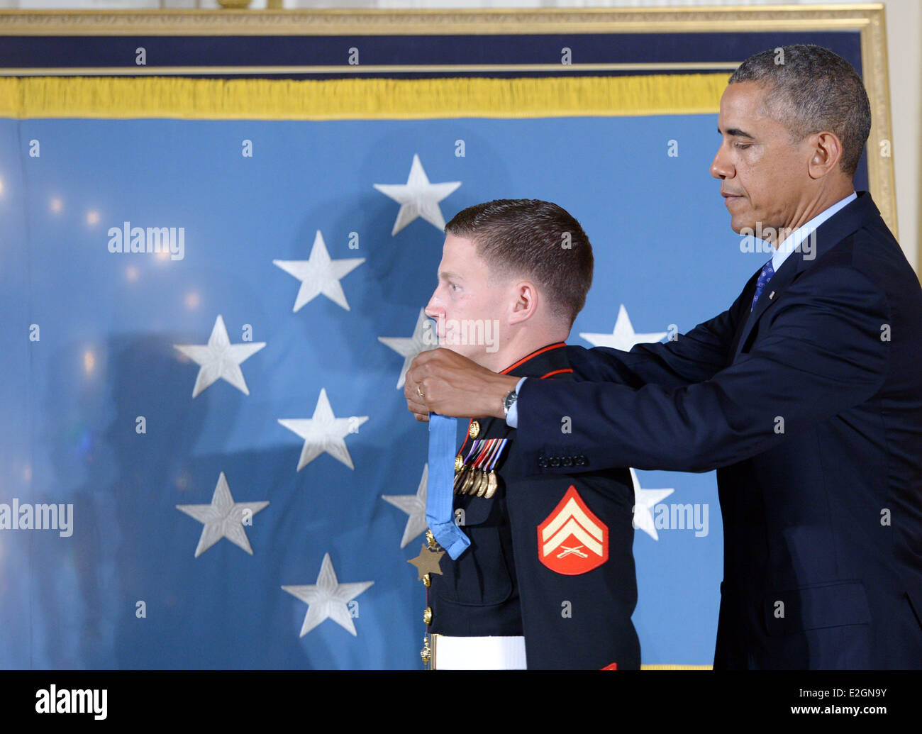 Washington, DC, USA. 19th June, 2014. William 'Kyle' Carpenter (L) receives the Medal of Honor from U.S. President Barack Obama during a ceremony in the East Room of the White House in Washington, DC, the United States, on June 19, 2014. Carpenter received the medal for covering a grenade to save fellow Marines during a Taliban attack in November 2010. Carpenter is the eighth living recipient chosen for the highest military award. Credit:  Yin Bogu/Xinhua/Alamy Live News Stock Photo