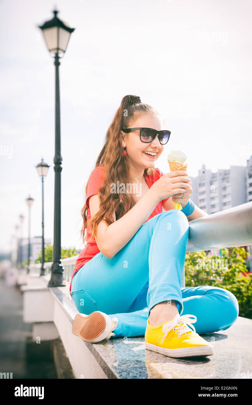 adorable teenager girl having fun and eating ice cream Stock Photo