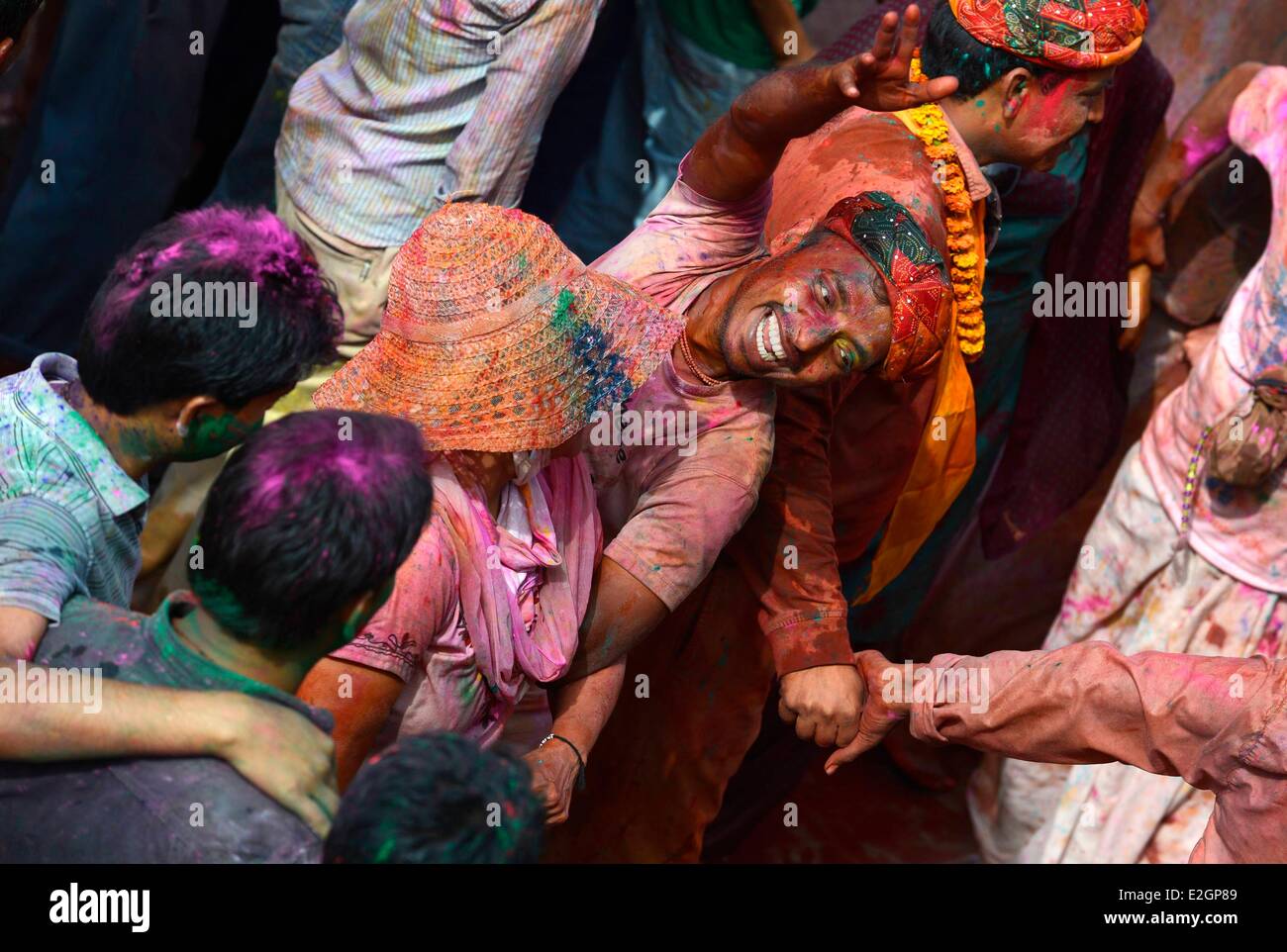 India Uttar Pradesh State in Barsana temple people receive coloured powder during Holi festival celebrations Stock Photo