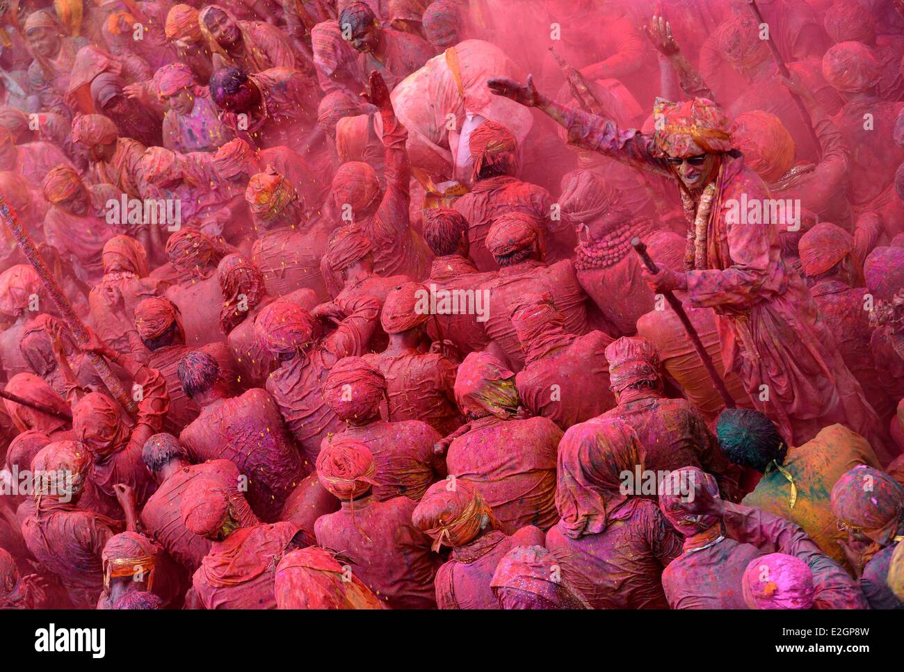 India Uttar Pradesh State in Barsana temple musicians receive coloured powder during Holi festival celebrations Stock Photo