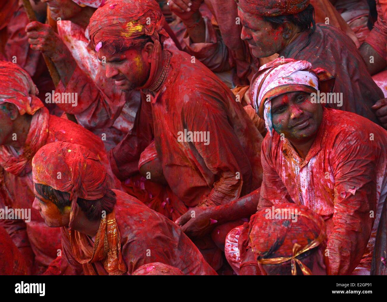 India Uttar Pradesh State in Barsana temple musicians receive coloured powder during Holi festival celebrations Stock Photo