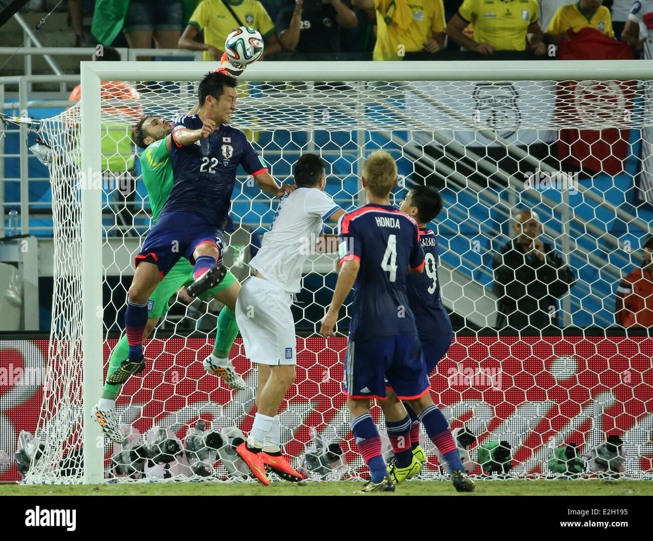 Natal, Brazil. 19th June, 2014. World Cup finals 2014. Group C stage match Japan versus Greece. Yoshida wins the header against Karnezis Credit:  Action Plus Sports/Alamy Live News Stock Photo