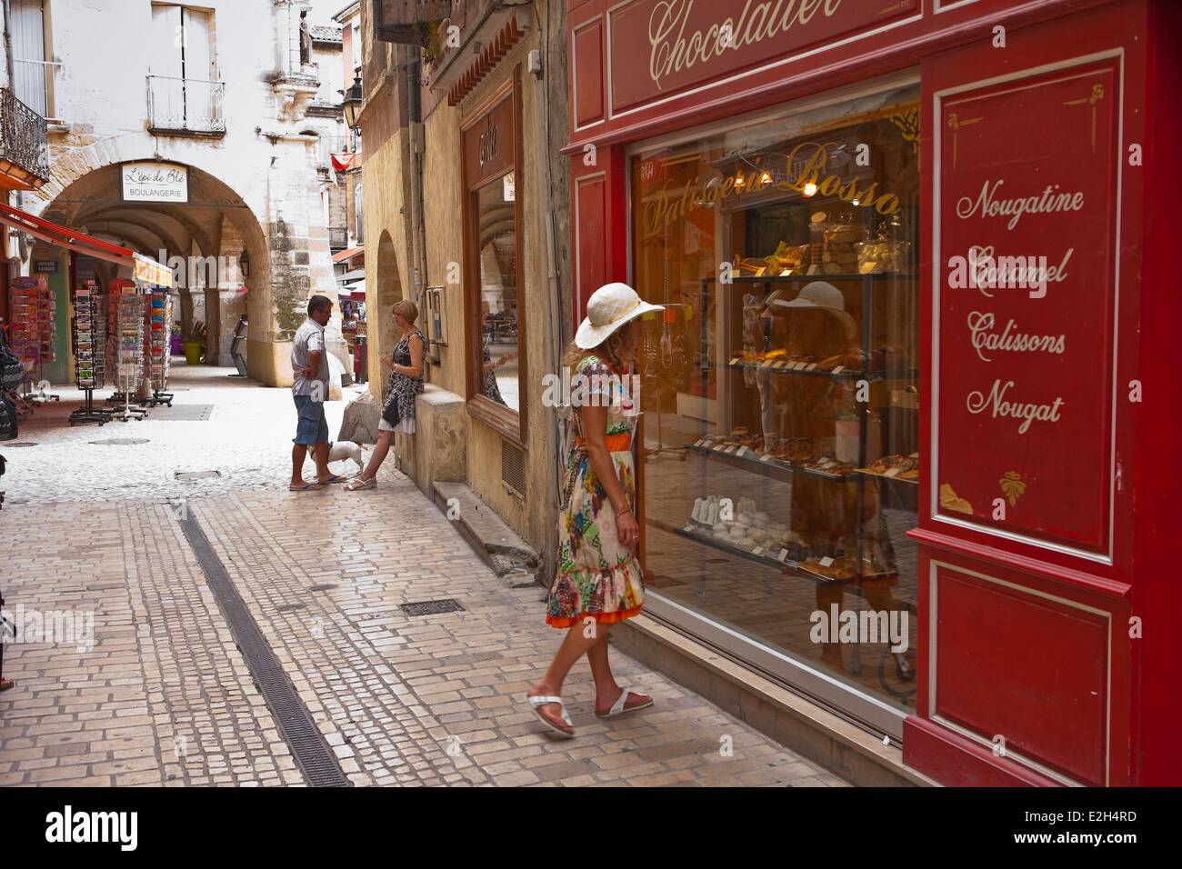 France Gard Sommieres woman outside a shop in a pedestrian street Stock Photo