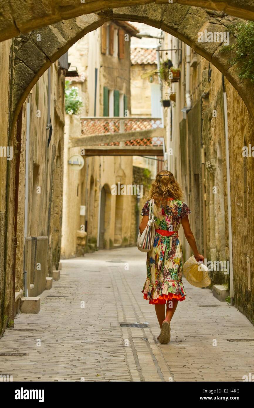 France Gard Sommieres woman walking down a street in arcades Stock Photo