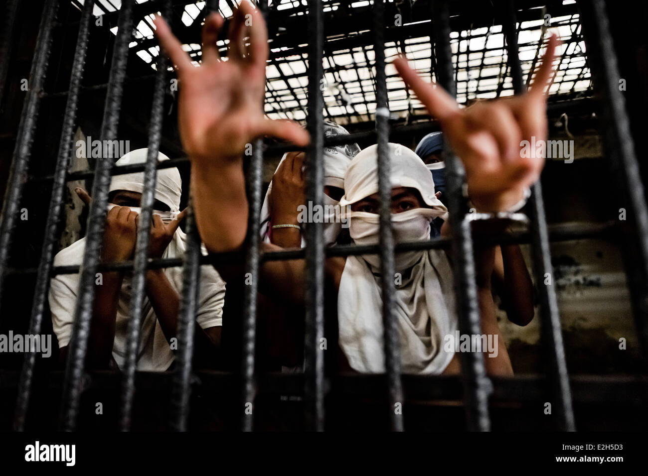 The Mara Salvatrucha gang members show finger signs representing their gang while being detained in San Salvador, El Salvador. Stock Photo
