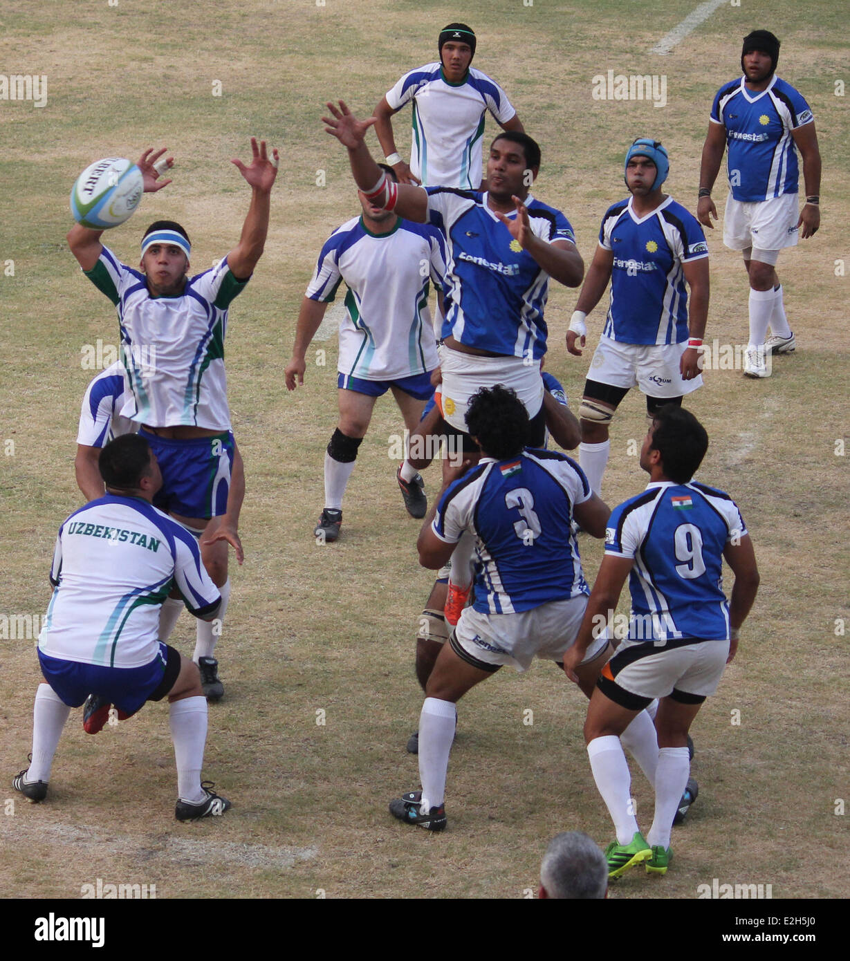Indian rugby players (blue shirt) fight 
