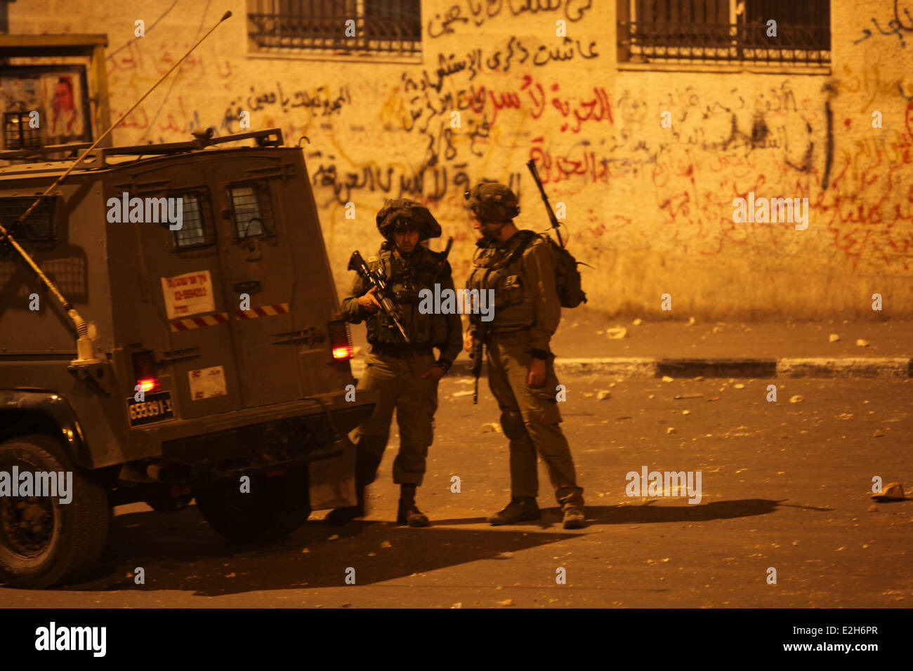 Bethlehem, West Bank. 20th June, 2014. Israeli soldiers patrol during a military operation to search for three missing Israeli youths in the Deheishe refugee camp in Bethlehem, on June 20, 2014. Israeli officials tried to reassure the public that authorities were doing everything in their power to retrieve the three missing Israeli teens presumed to be abducted a week ago in the West Bank. Credit:  Luay Sababa/Xinhua/Alamy Live News Stock Photo