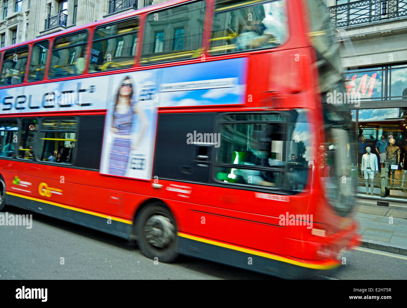 Red double-decker bus in transit on Regent Street, City of Westminster, London, England, United Kingdom Stock Photo