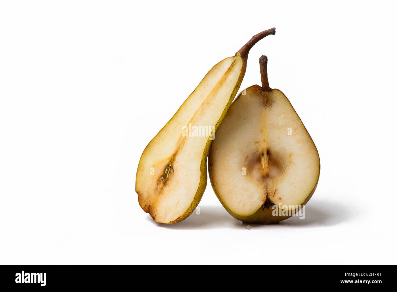 Two pear fruits halves of different shapes leaning against each other Stock Photo
