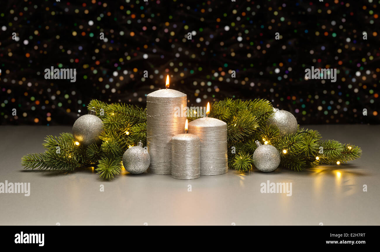 Three Silver Candles with Christmas tree branches decorated Stock Photo