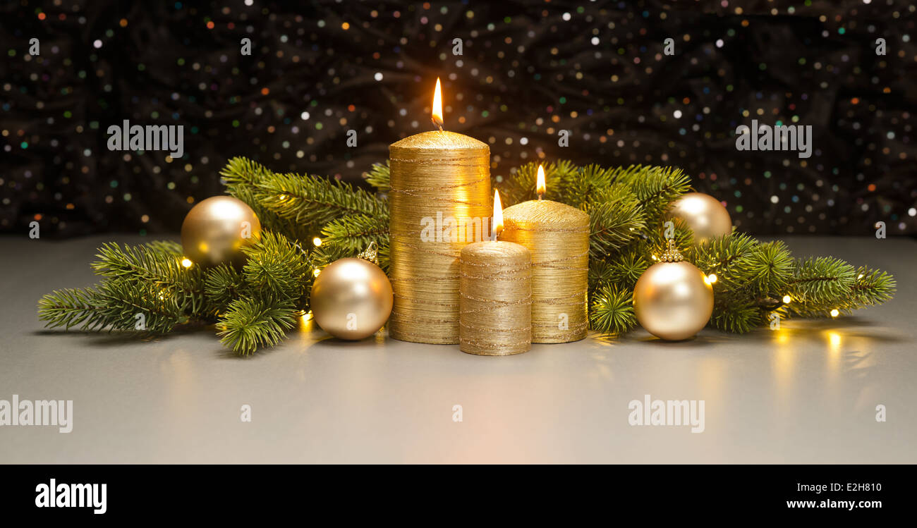 Three golden Candles with Christmas tree branches decorated Stock Photo