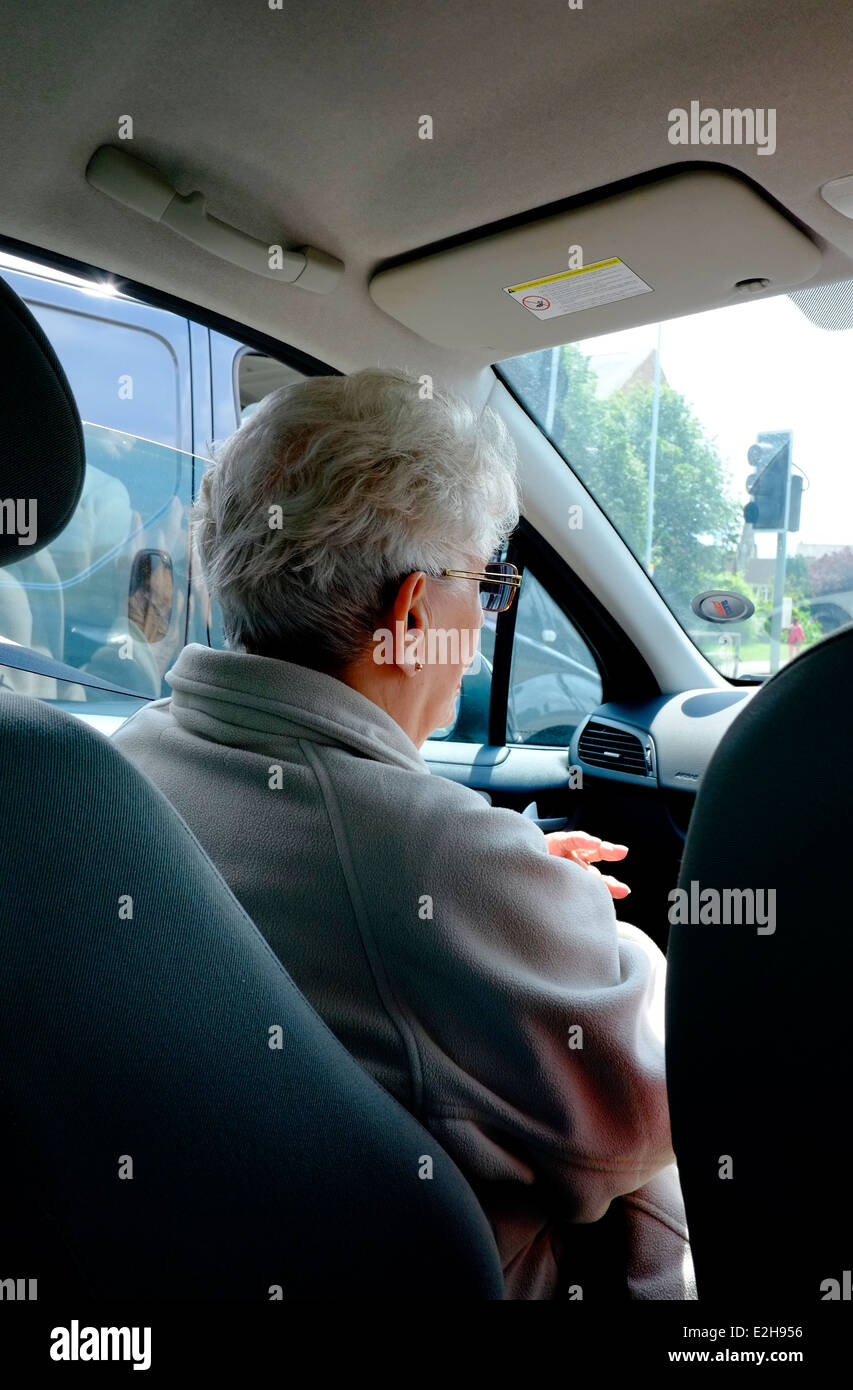 An elderly senior woman passenger in a car England UK Stock Photo