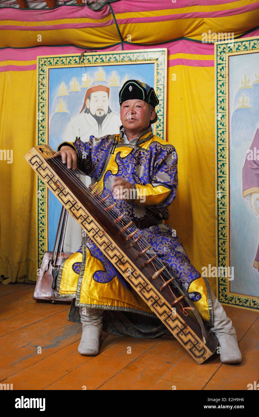 Man in the traditional costume of the Khalkha Mongols playing the Mongolian Zither, Kharkhorin, Southern Steppe Stock Photo