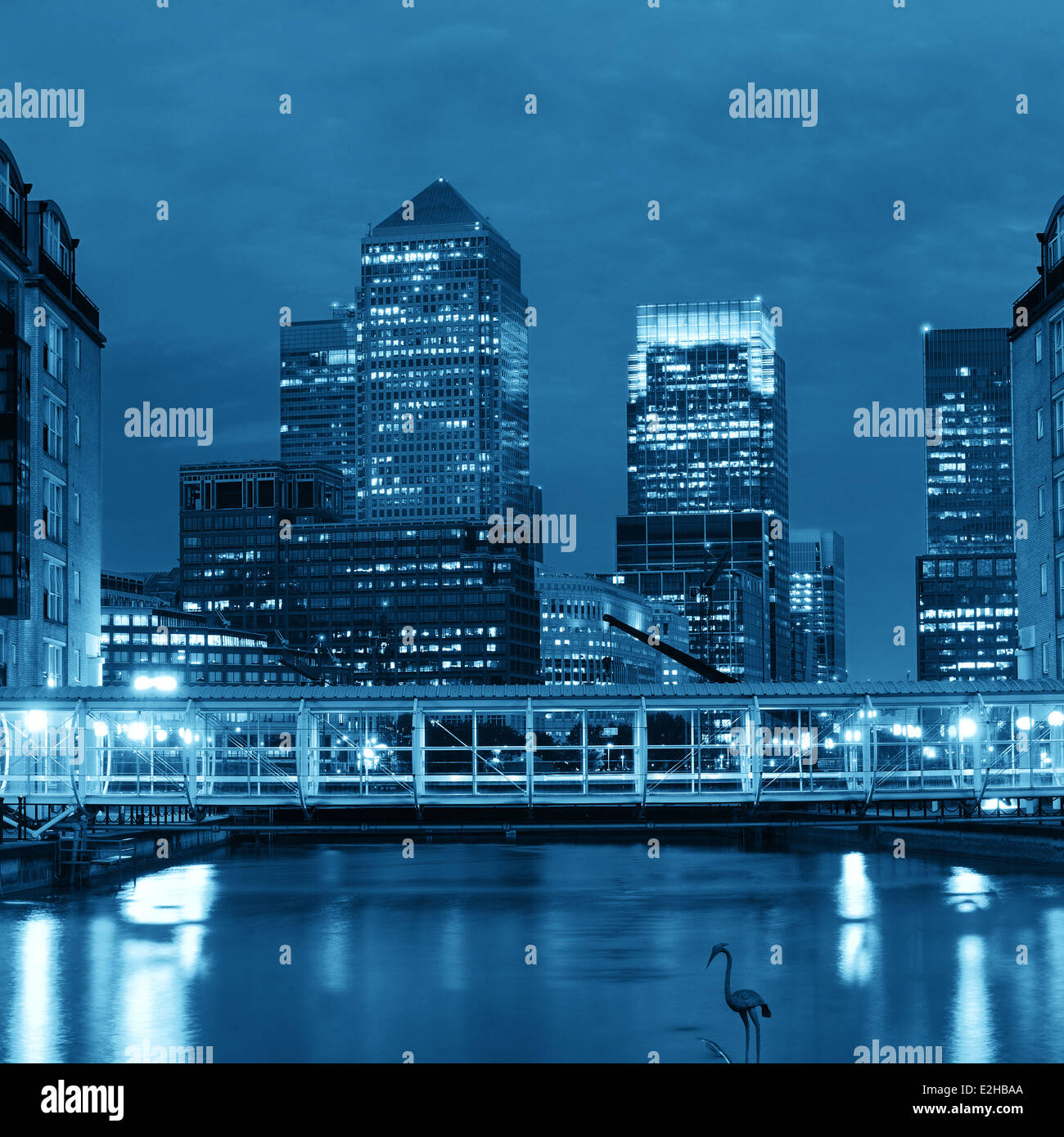 Canary Wharf business district in London at night over Thames River ...