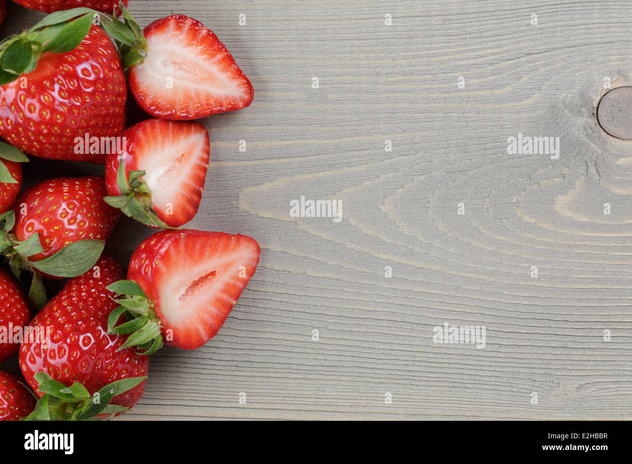 ripe strawberries on wood table, rustic simple style Stock Photo - Alamy