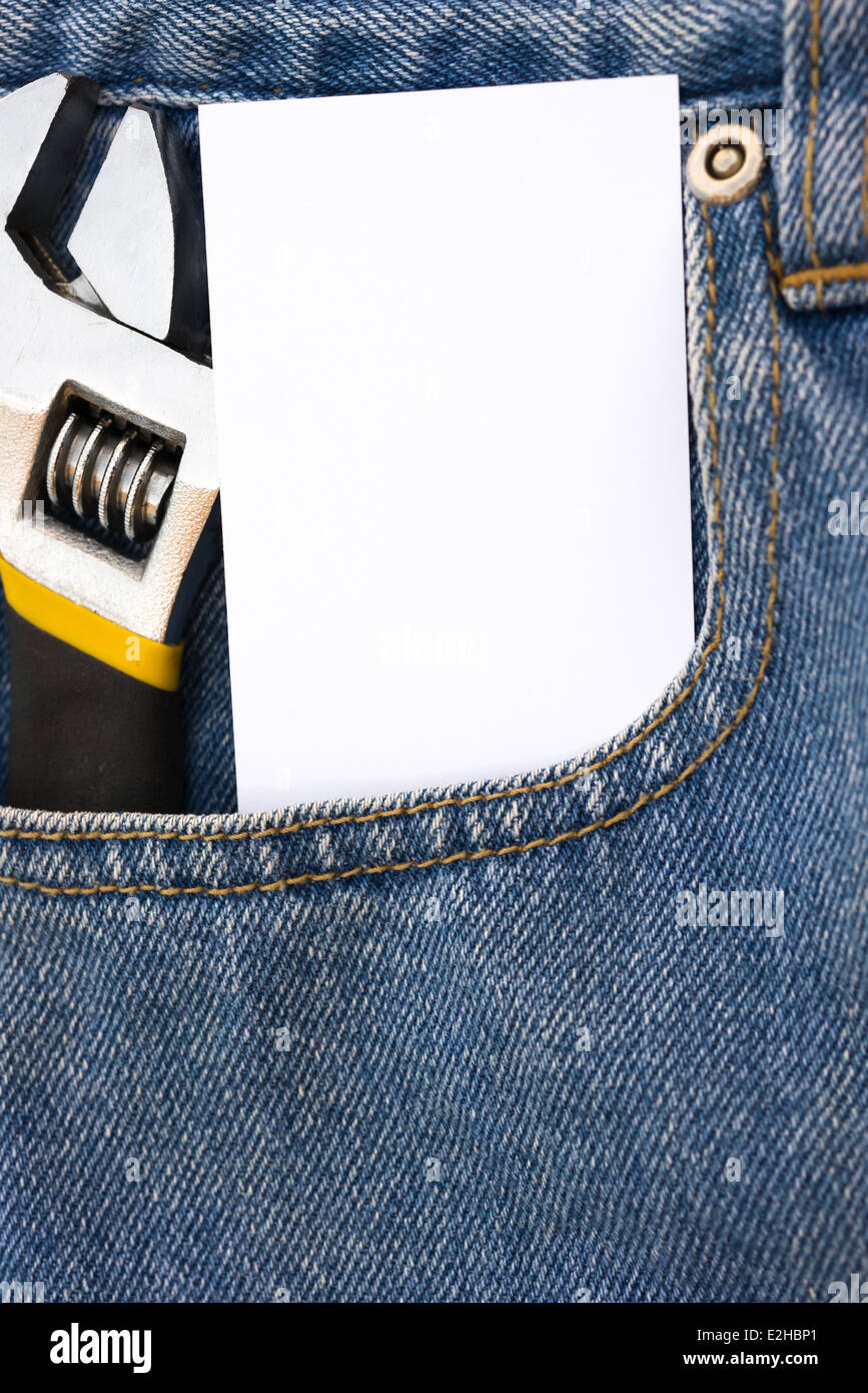 blank card and wrench on blue jean Stock Photo