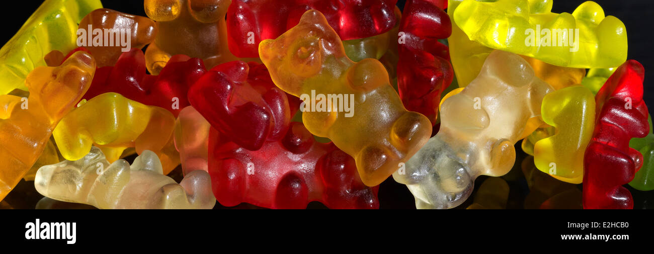colorful pile of gummy bears in black back Stock Photo