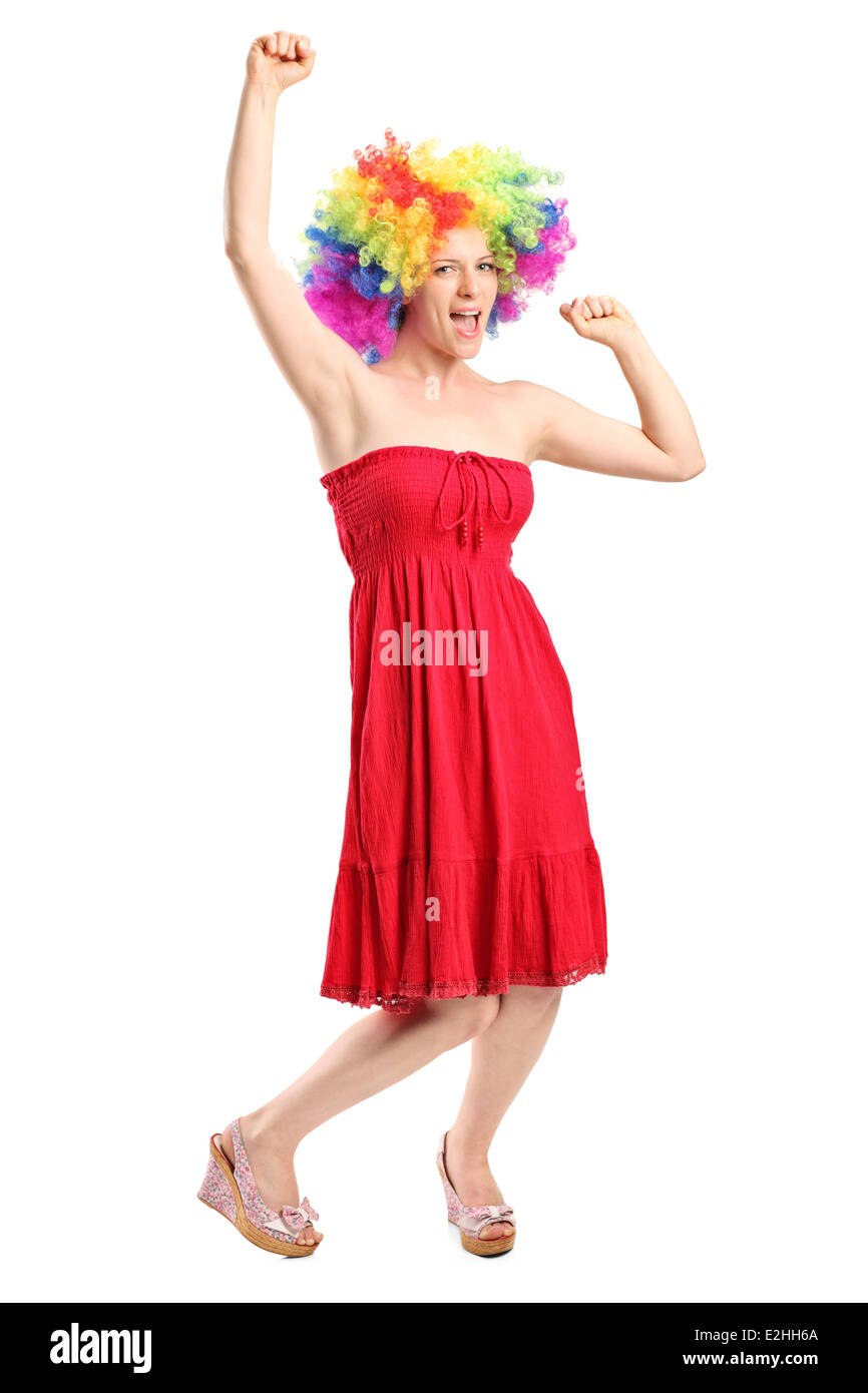 Full length portrait of a happy young woman with a wig gesturing joy Stock Photo