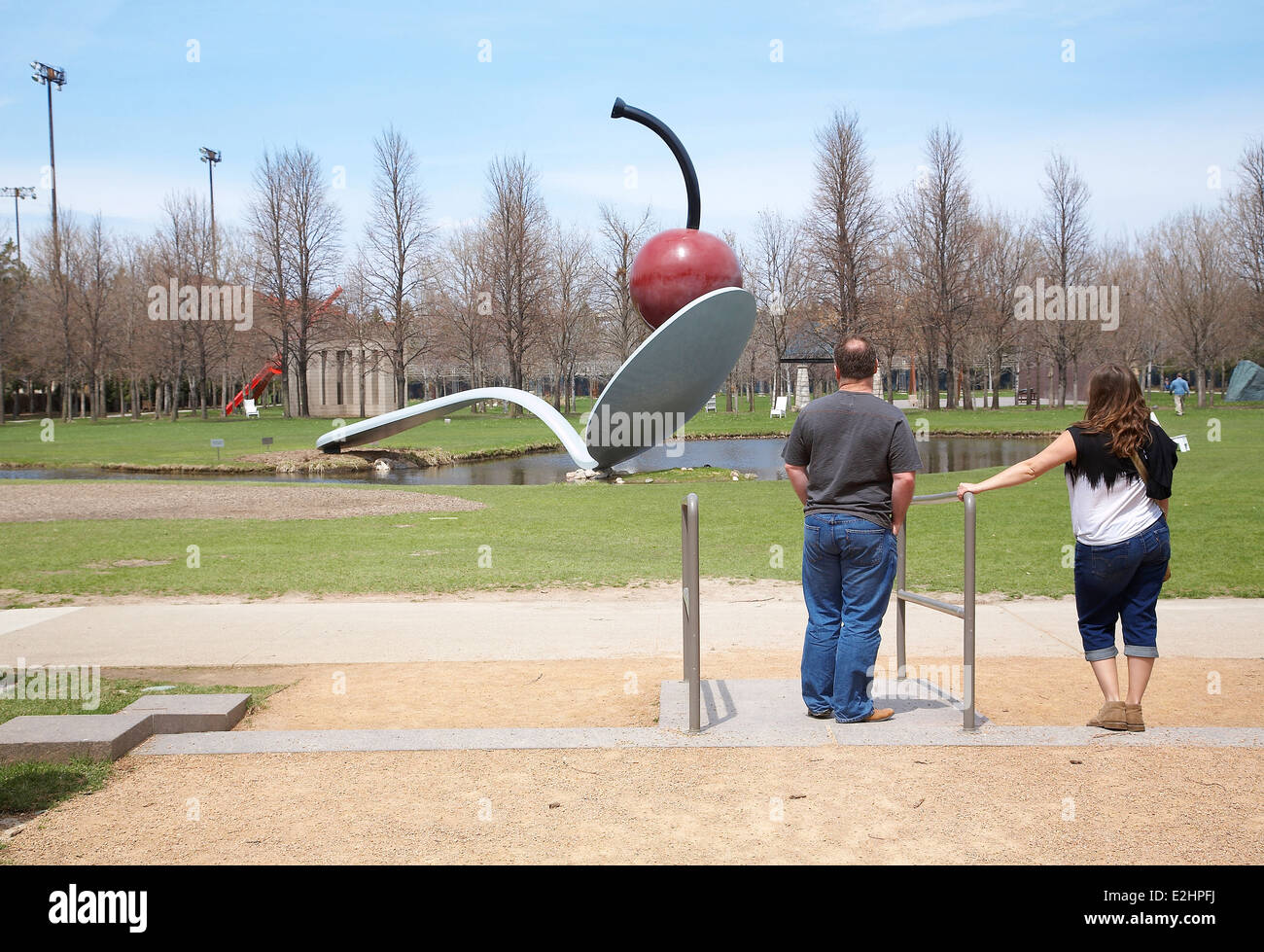Two people looking at the Spoonbridge and cherry at  Minneapolis sculpture garden, Walker art center. MRs Available if needed. Stock Photo