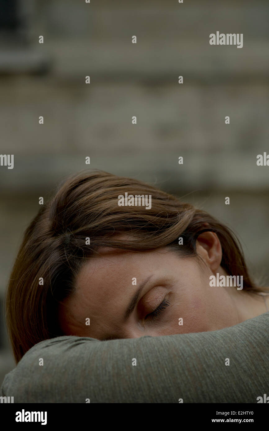 Woman resting head on arms Stock Photo Alamy