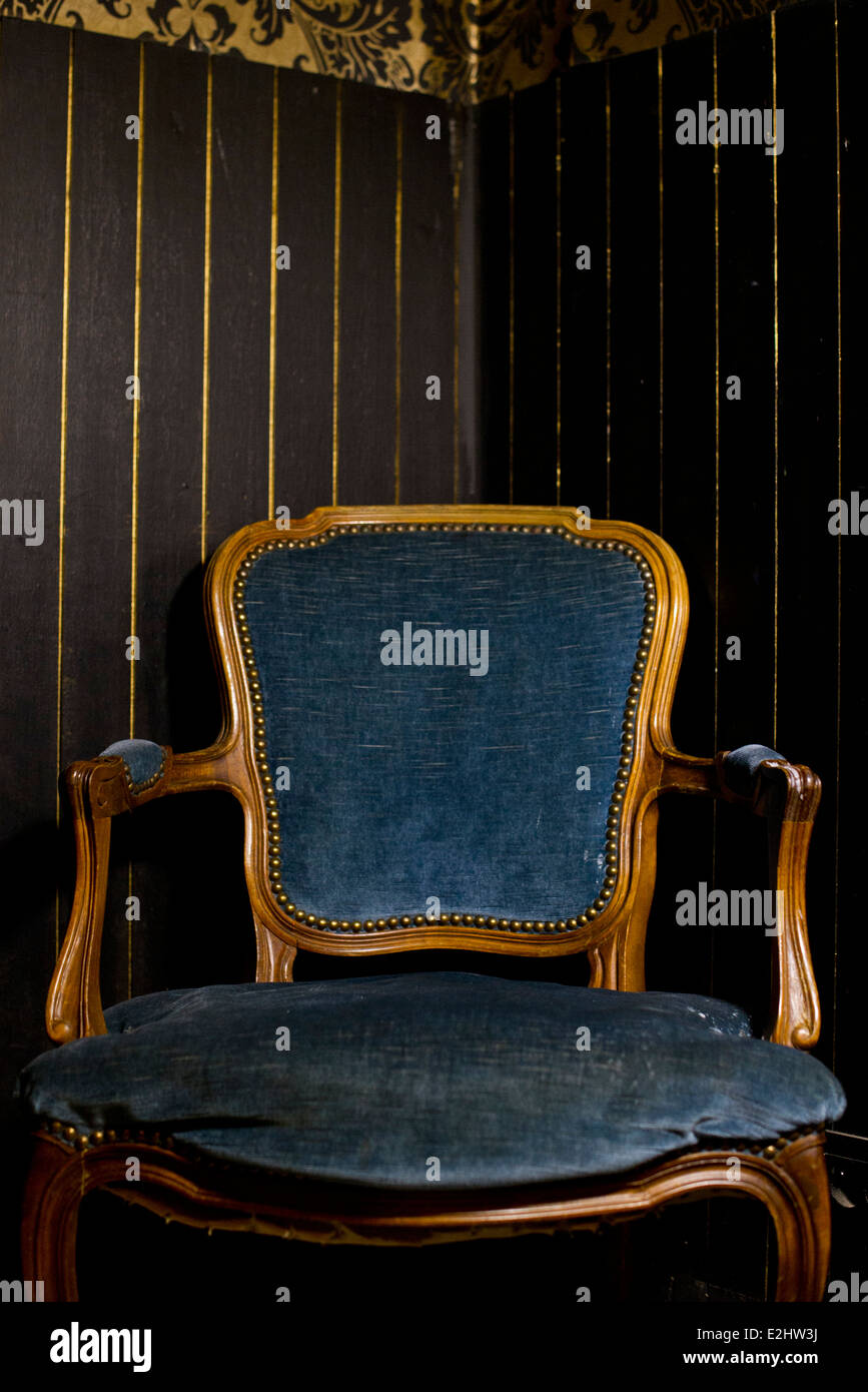 Velvet armchair in dark room Stock Photo