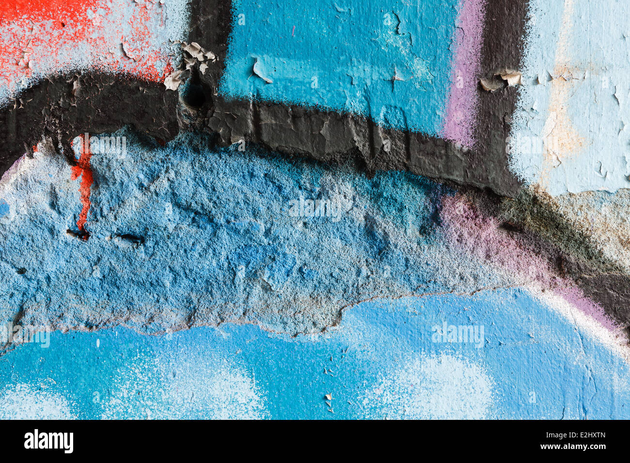 Closeup of a damaged graffiti wall Stock Photo