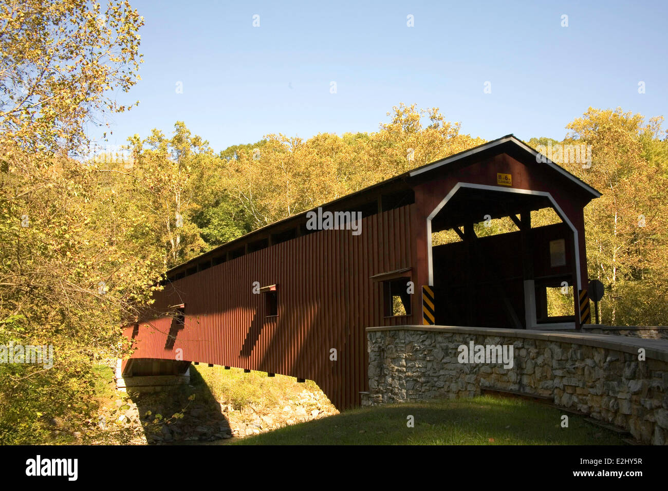 Colemanville Covered Bridge in the Pennsylvania Dutch Countryside of Lancaster County surrounded by fall foliage. Stock Photo