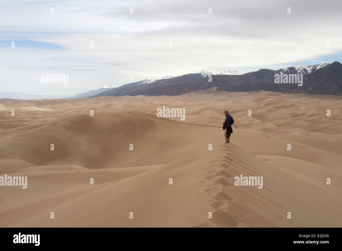 Hiker admiring view at Great Sand Dunes National Park and Preserve Stock Photo