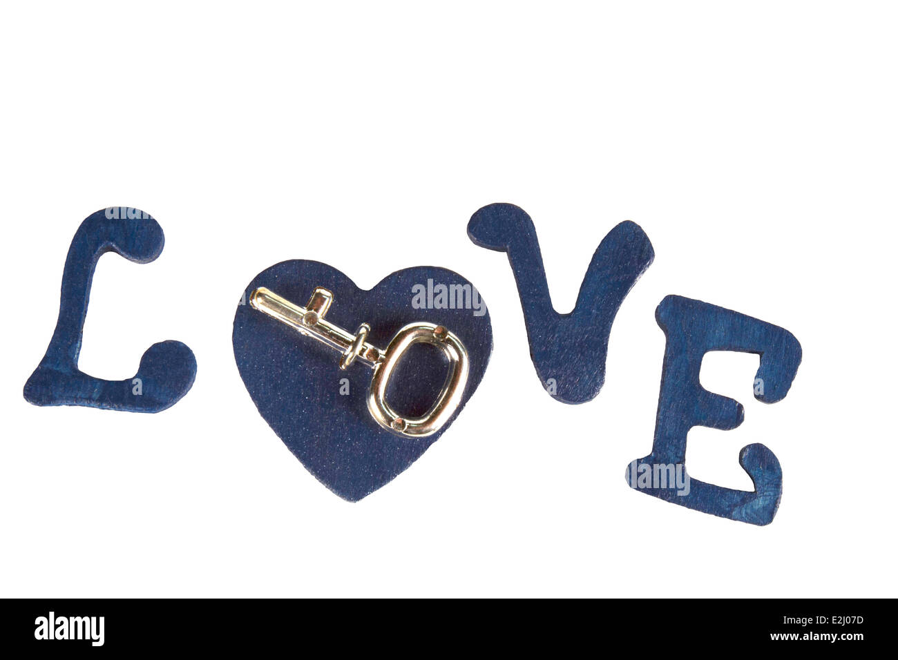 Key on a heart in the word LOVE spelled in wooden letters Stock Photo