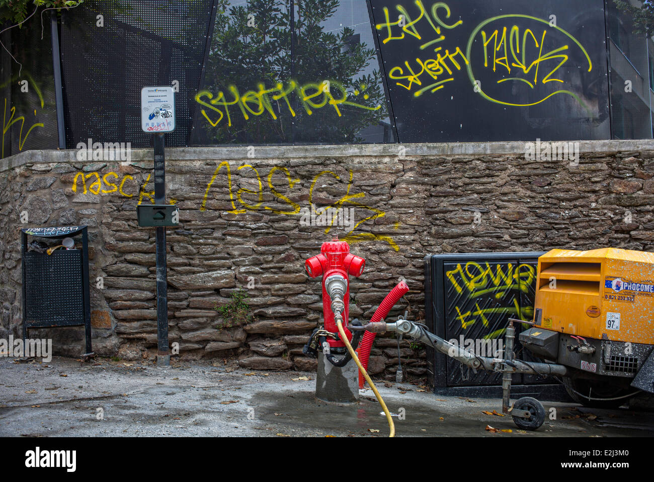 Fire hydrant on graffitied street corner Stock Photo