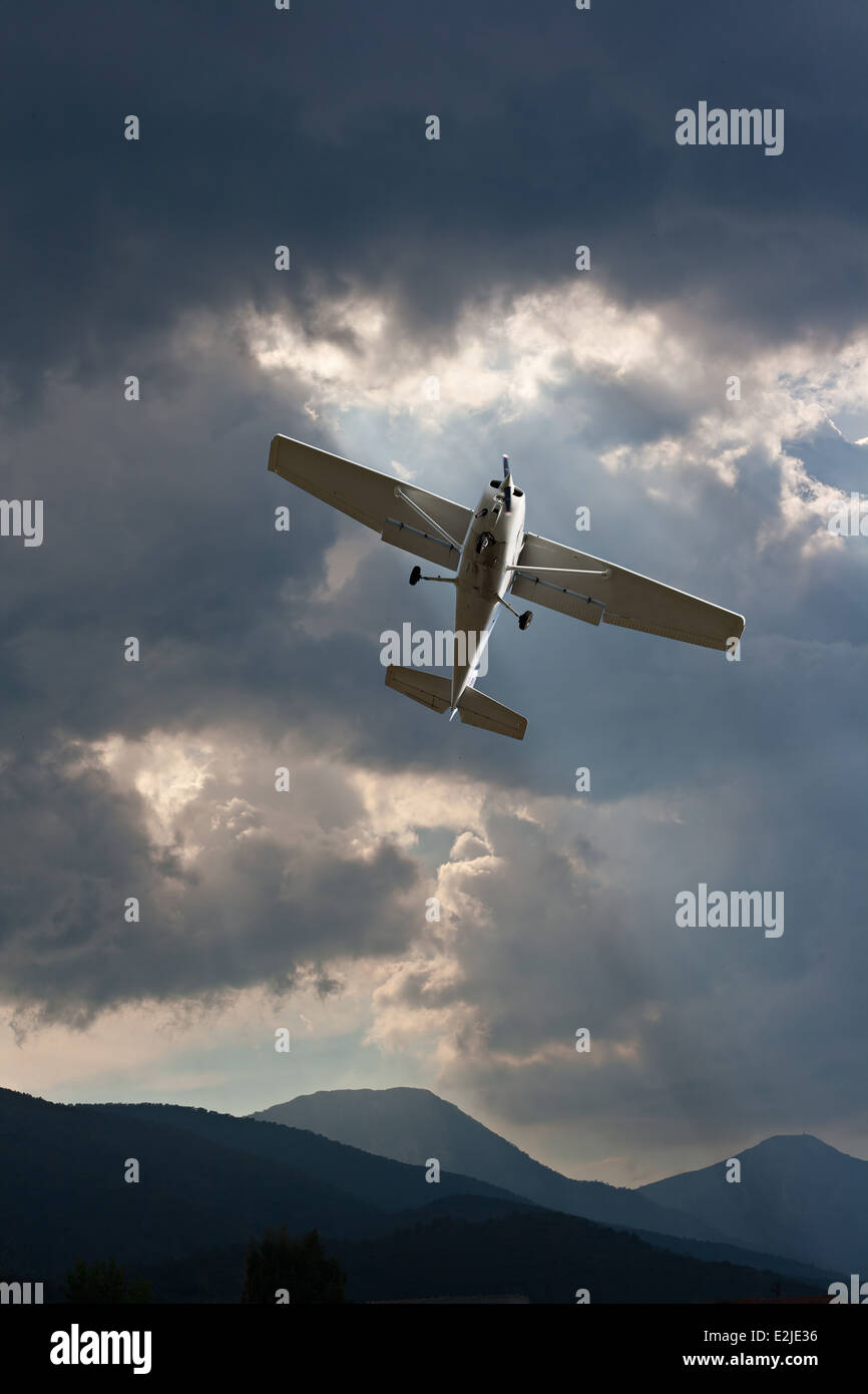 Small fixed wing plane against a stormy sky Stock Photo
