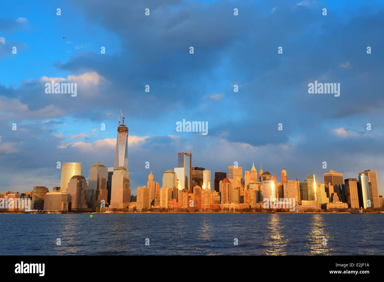 Downtown Manhattan skyline at sunset over Hudson River in New York City ...