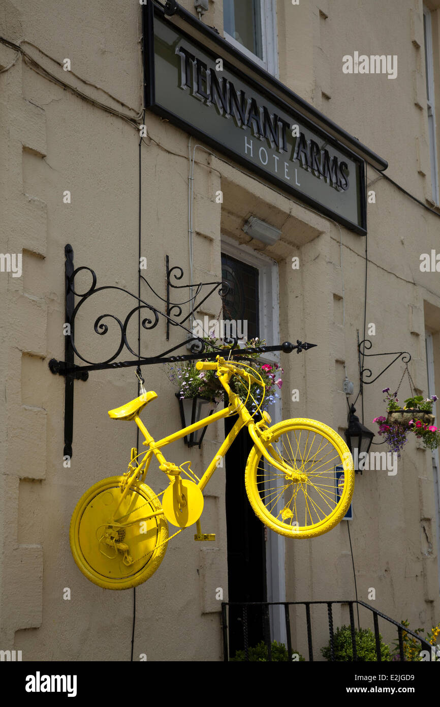 2014 Tour de France, yellow painted bicycles decorate the route in Kilnsey, Yorkshire Dales, UK. The race will start in the county on 5th & 6th July 2014 bringing millions of fans to the Yorkshire roadside to cheer on the champions of the sport.  It will be the first time Le Tour has visited the north of England. Stock Photo