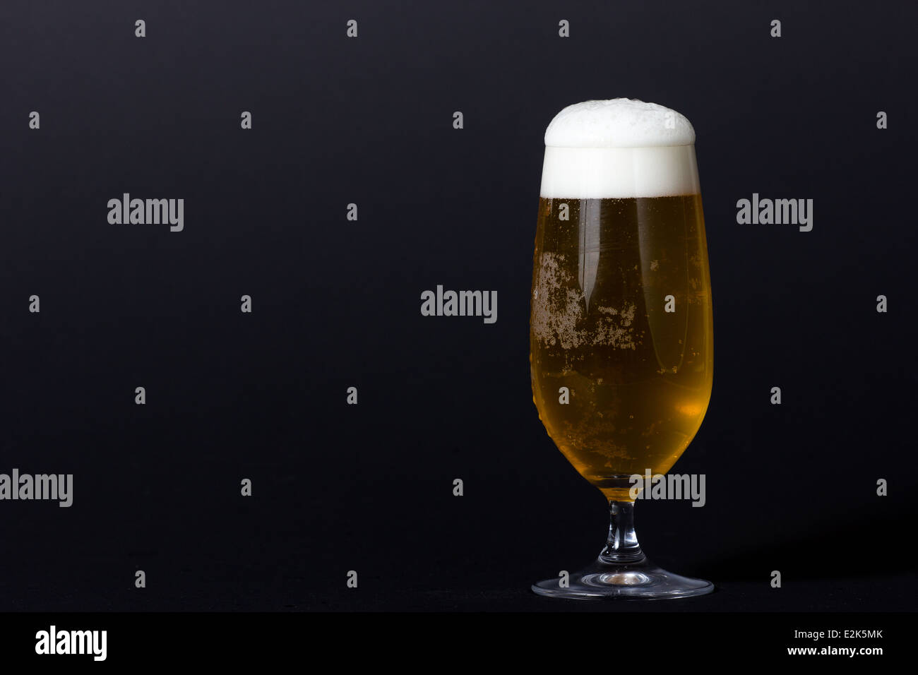 Fresh served cold beer in a glass with foam Stock Photo