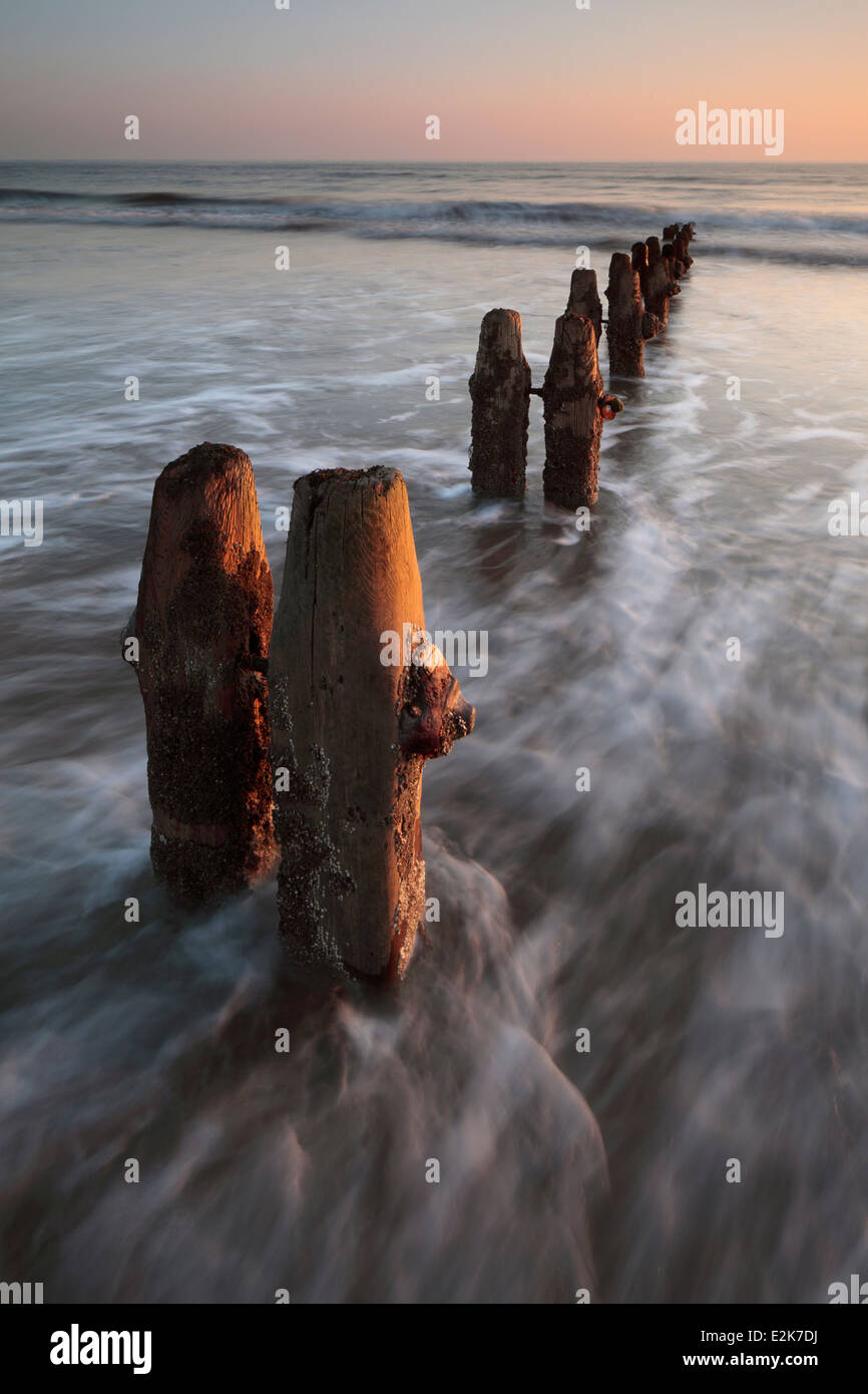 Groynes and surf at Sandsend near Whitby in North Yorkshire, England Stock Photo
