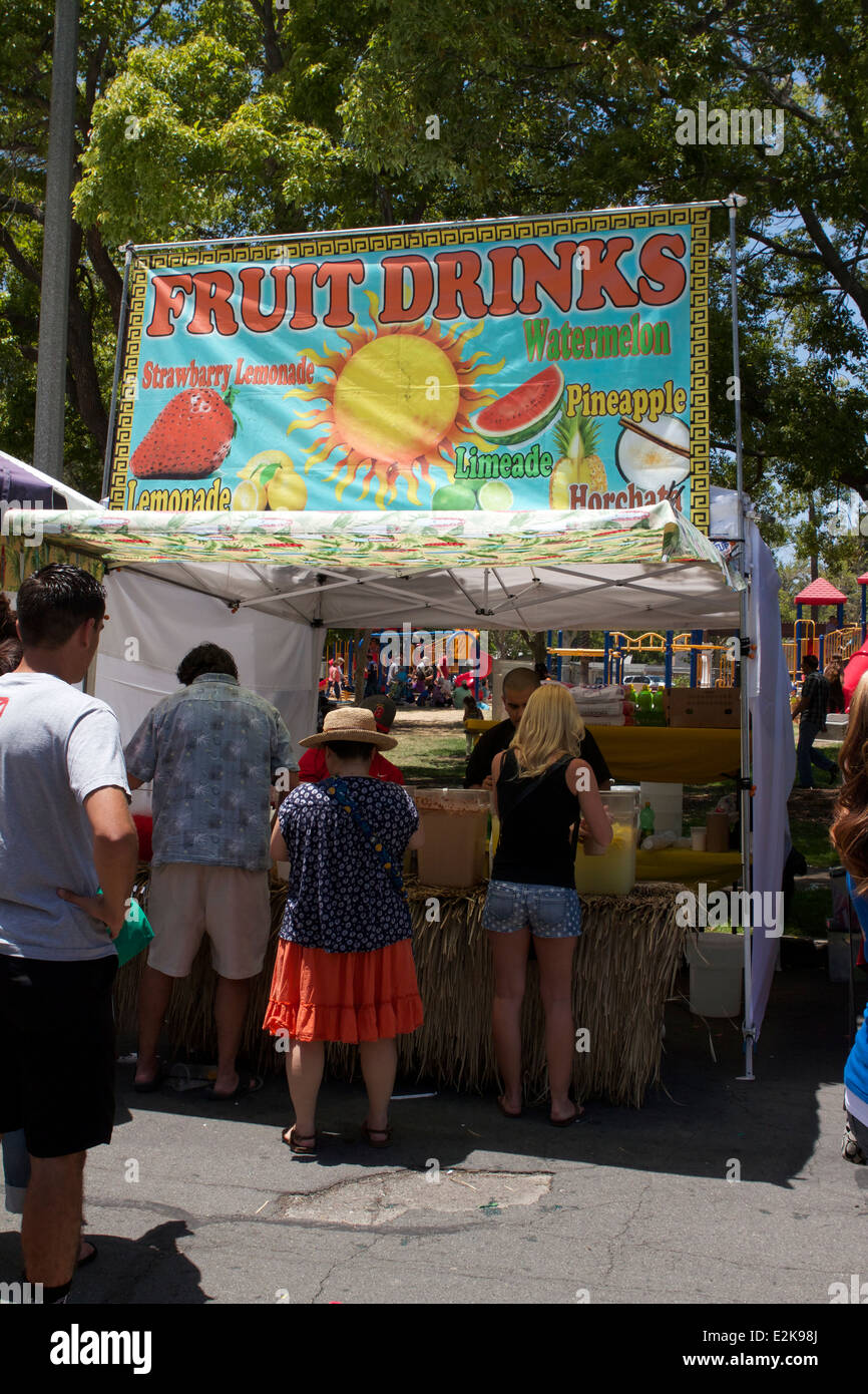 Vendors selling Ice cold fruit juice drinks at a street fair in Tustin
