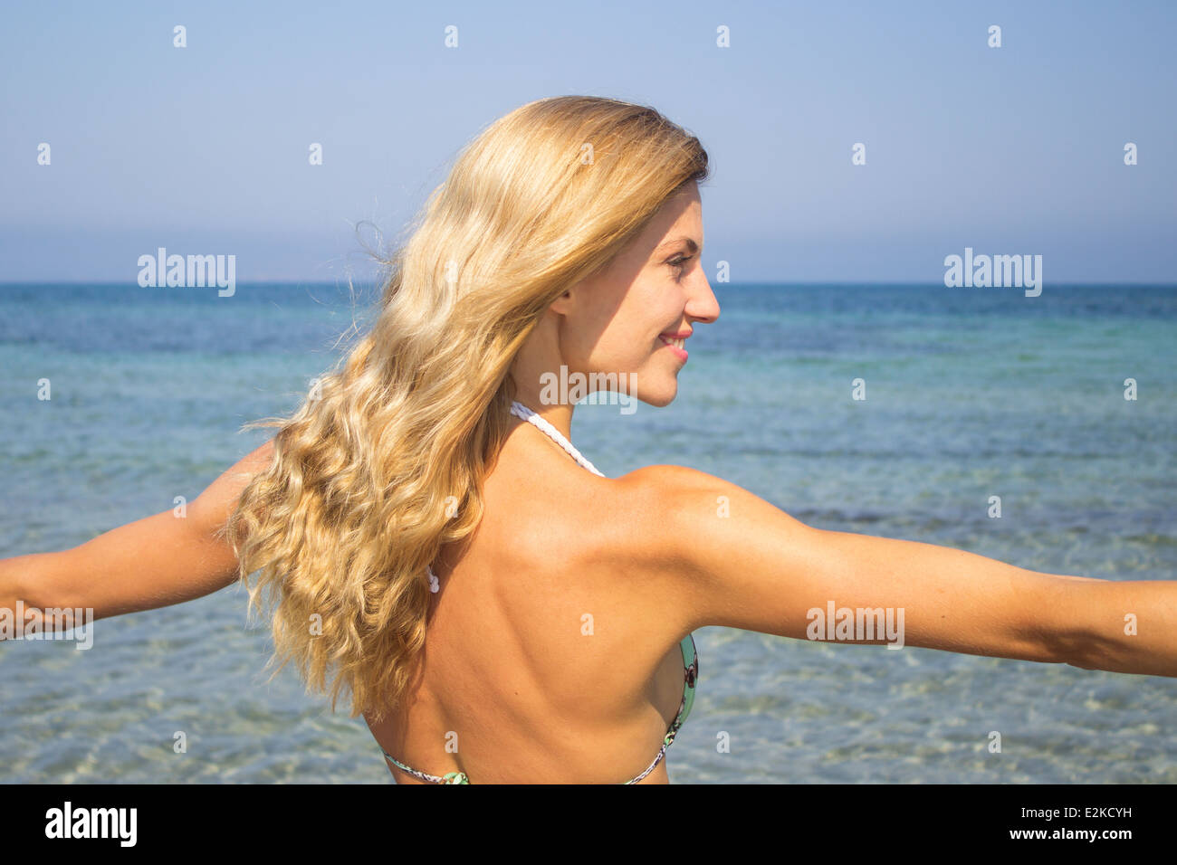 woman bikini portrait sea ocean beach summer vacation holidays free freedom happy smiling smile positive 'hands in air' side Stock Photo