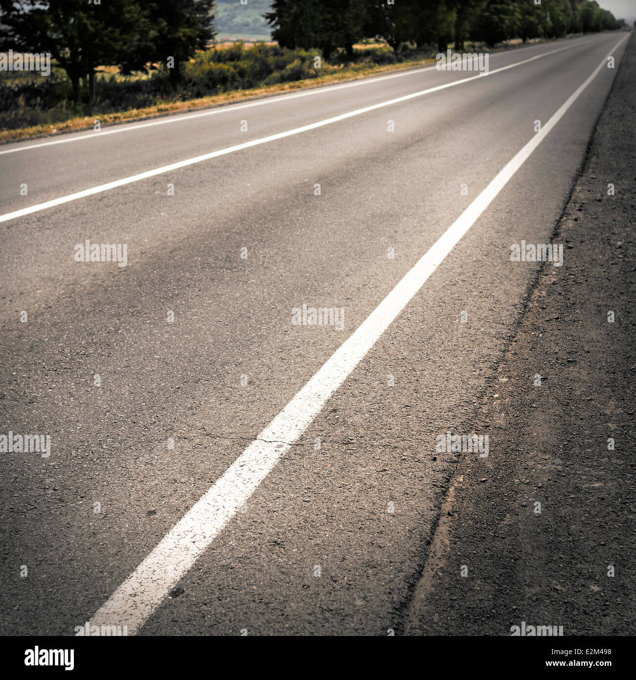 The asphalted road stretches into the distance Stock Photo - Alamy