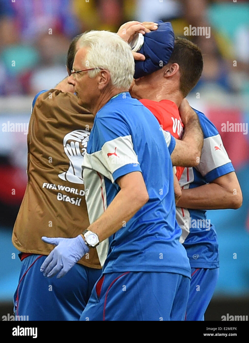 Salvador, Brazil. 20th June, 2014. Switzerland's Steve von Bergen (R) is led off the pitch due to an injury during the FIFA World Cup 2014 group E preliminary round match between Switzerland and France at the Arena Fonte Nova in Salvador, Brazil, 20 June 2014. Photo: Marius Becker/dpa/Alamy Live News Stock Photo