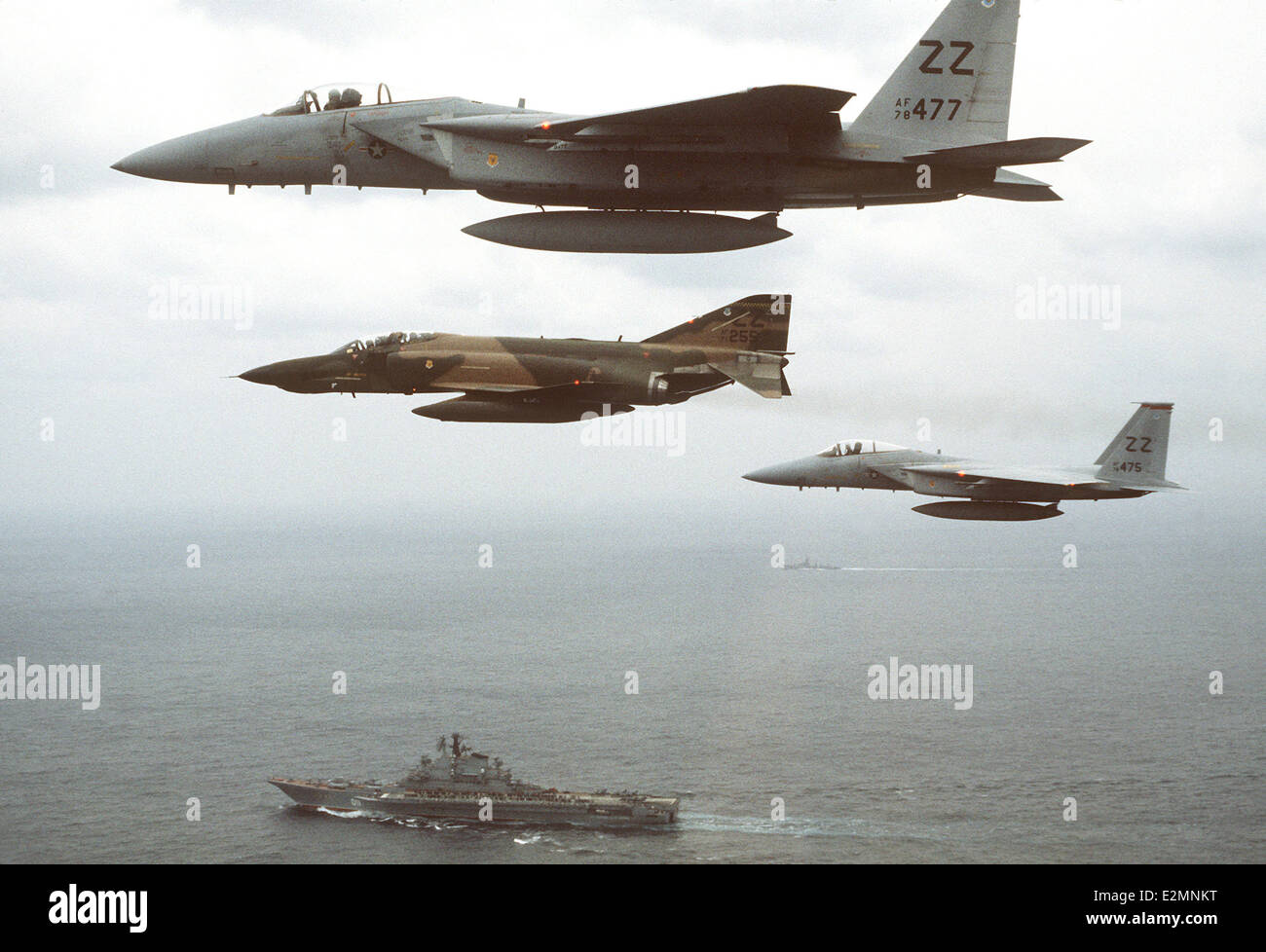 RF-4C Phantom II aircraft and two F-15 Eagle aircraft flying over the Soviet Kiev-class aircraft carrier Minsk Stock Photo