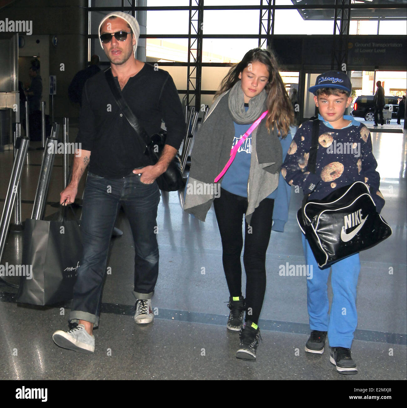 Jude Law with his daughter Iris and son Rudy arrive at Los Angeles  International Airport, LAX looking tanned and relaxed after their holiday  Featuring: Jude Law,Iris Law,Rudy Law Where: Los Angeles, California,