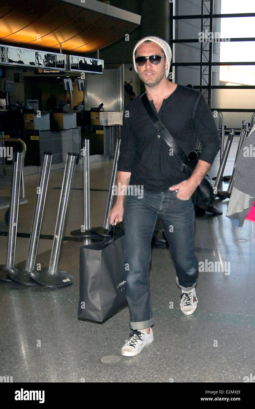 Jude Law with his daughter Iris and son Rudy arrive at Los Angeles International Airport, LAX looking tanned and relaxed after their holiday  Featuring: Jude Law Where: Los Angeles, California, USA When: 03 Jan 2013 Stock Photo