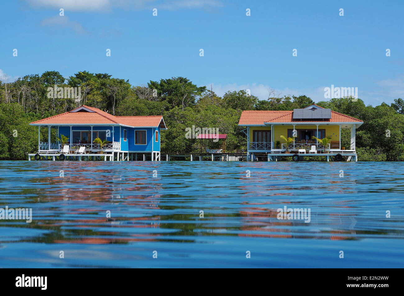 Off grid over water bungalows, one with solar panels, Caribbean sea, Panama Stock Photo