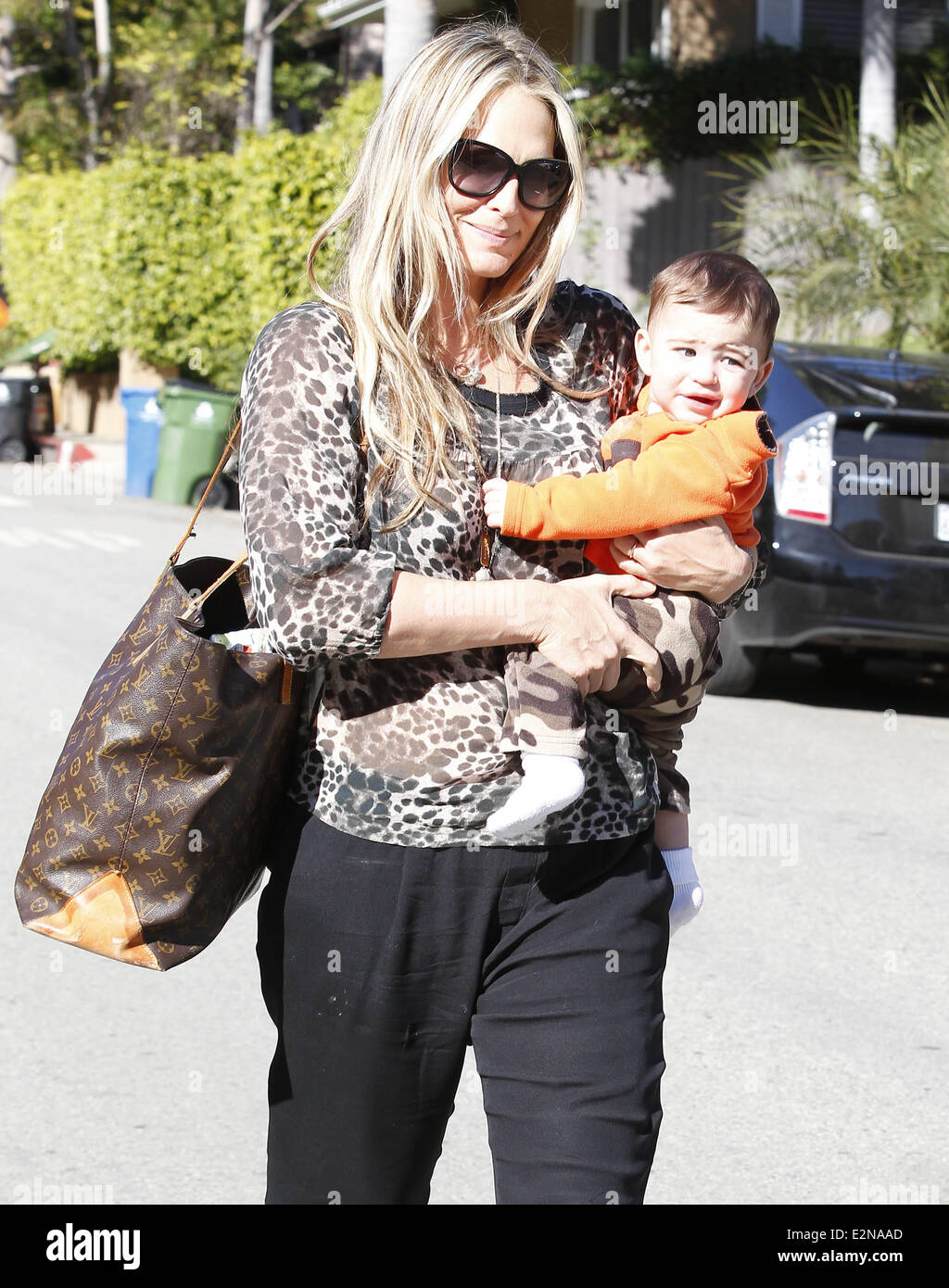 Molly Sims and her son Brooks out and about in Beverly Hills. Molly is  wearing a leopard print design top with black trousers, accompanied by a  over-sized Louis Vuitton leather bag Featuring