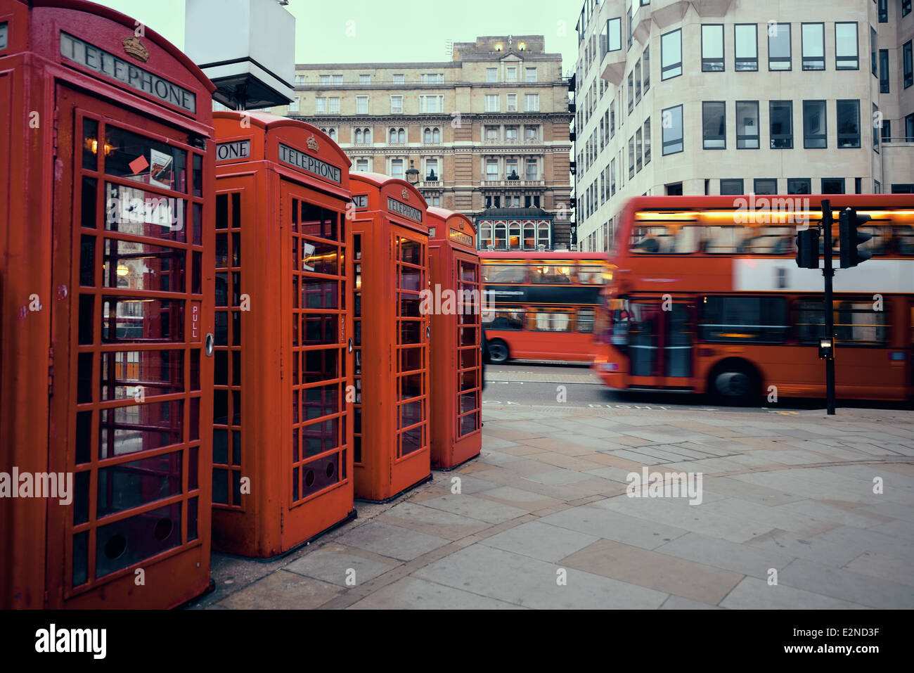 Red telephone box and bus in street with historical architecture in London. Stock Photo